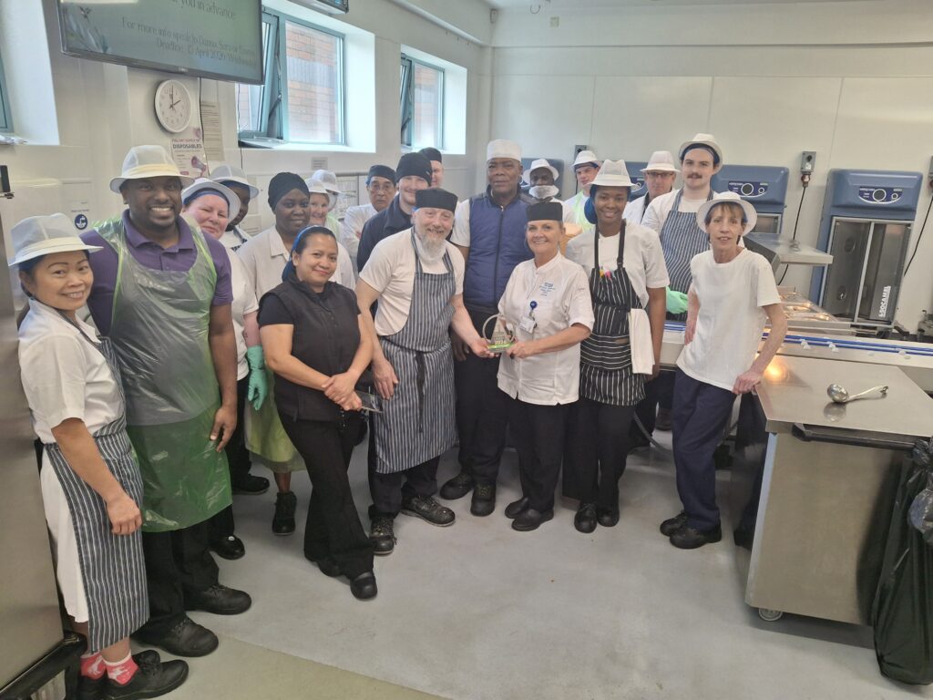 Catering award team members in hospital kitchens with their trophy