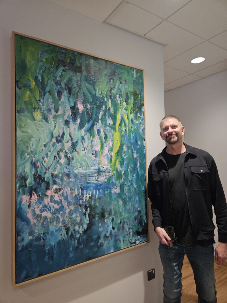 Ian Rayner-Smith with his artwork at the centre