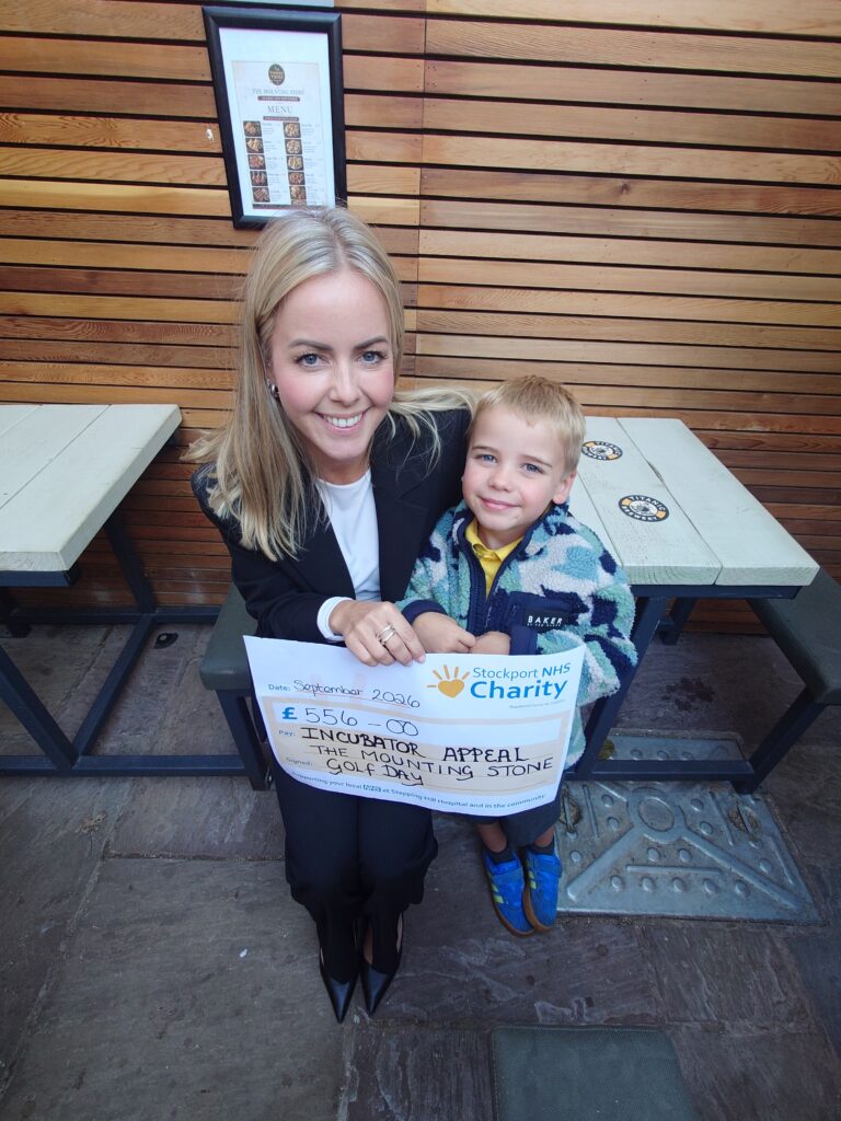 Roman and mem Rebecca with charity fundraising cheque