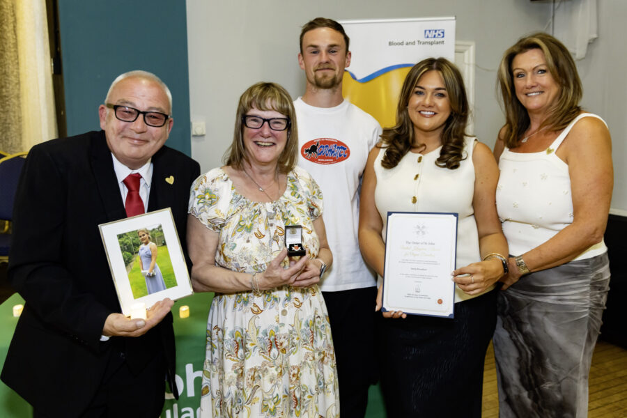 Karen Broadbent and family receiving Order of St John award, with portrait of daughter Emily