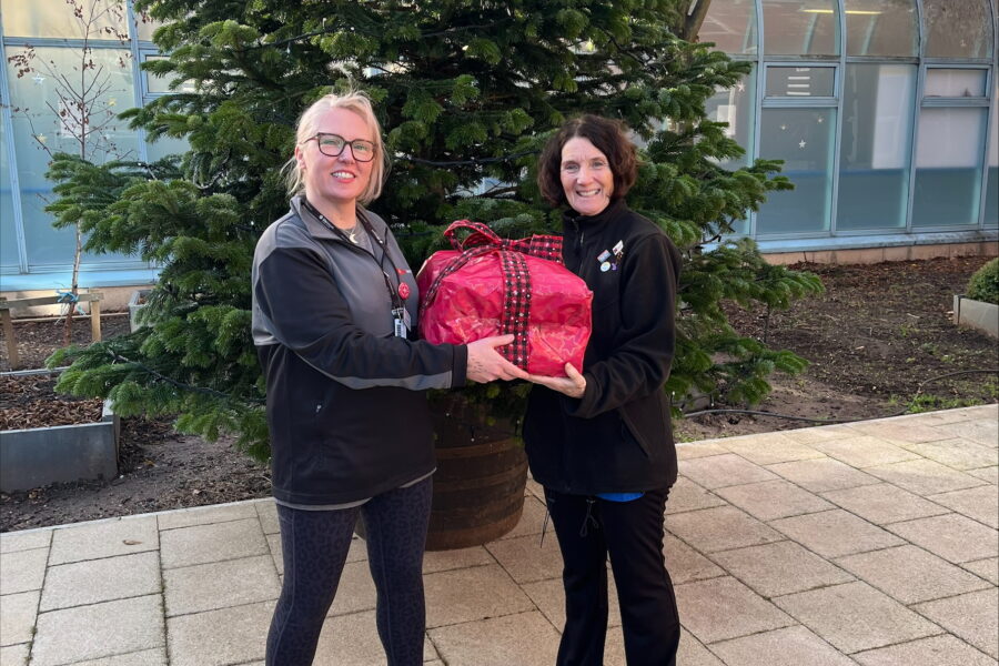 Two women standing with kit bags