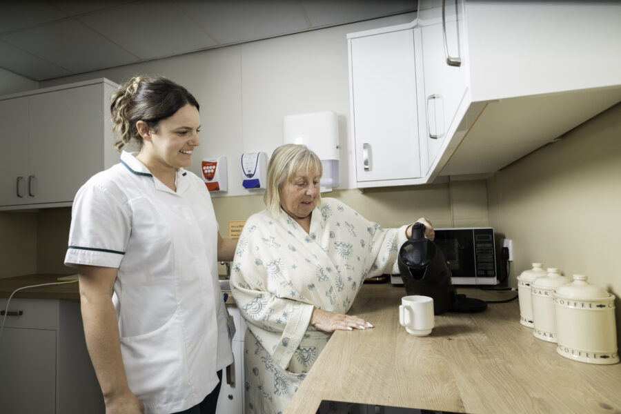 Therapist with woman making tea