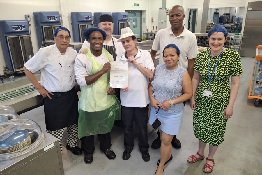 Members of catering team with exemplar award certificate