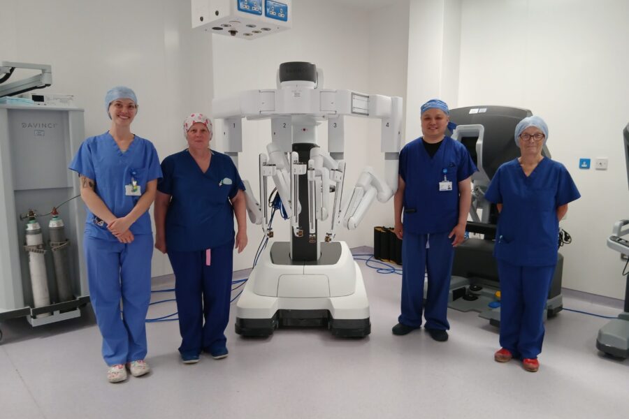 Da Vinci robot with surgical team members